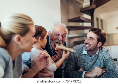 Three Generation Family Eating Pizza Together