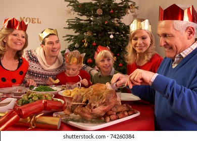 Three Generation Family Enjoying Christmas Meal At Home