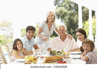 Three Generation Family Enjoying Meal Outdoors