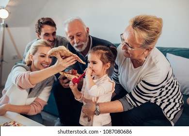 Three Generation Family Having Pizza Together