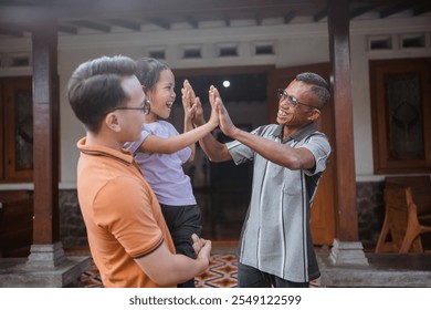 three generation family high five hand in front of grandfather house - Powered by Shutterstock