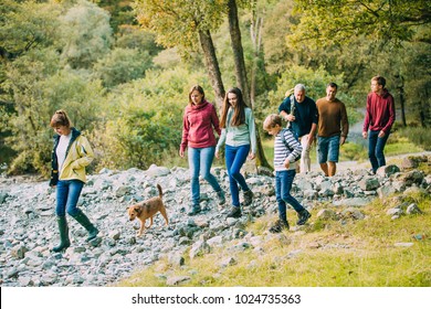 Three Generation Family Are Hiking Together Through The Lake District With Their Pet Dog.