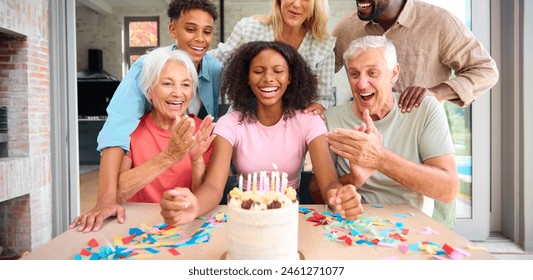 Three Generation Family Indoors At Home Celebrating Teenage Daughter's Birthday With Party And Cake - Powered by Shutterstock