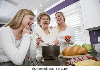 Three generation family in kitchen serving lunch, talking and laughing - Powered by Shutterstock