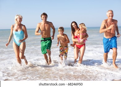 Three Generation Family Play On Beach