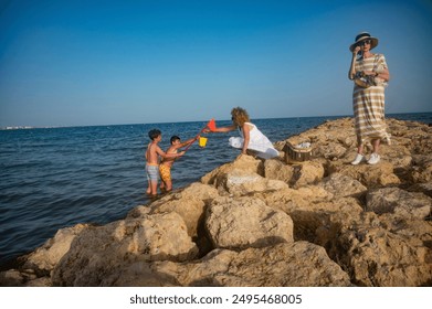 Three generation family playing and exploring on a rocky beach
 - Powered by Shutterstock