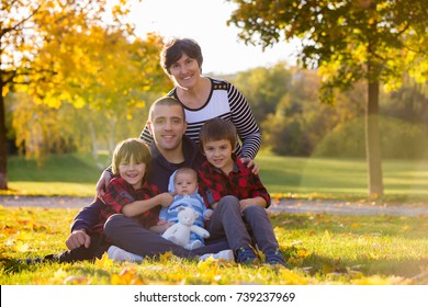 Three Generation Family Playing In The Park, Having Portrait Autumn Time. Family Concept