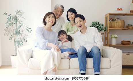 Three Generation Family Relaxing In The Living Room