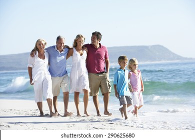 Three Generation Family Walking Along Beach