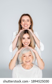 Three Generation Of Happy Women Isolated On Grey