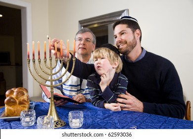 Three generation Jewish family lighting Chanukah menorah