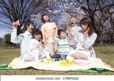 Three Generational Japanese  Family Surrounding A Lunch