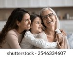 Three generational women embracing, smiling spending pleasant time together, celebrate life event, Happy Mother Day at home, close up. Family unity, love, deep connection between different generations