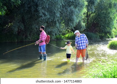 Three Generations Ages: Grandfather, Father And Young Teenager Son. Old And Young. Dad And Son Fishing At Lake