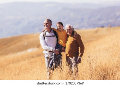 Three Generations Of Family Hiking Together In The Autumn.