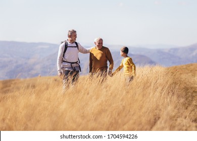 Three Generations Of Family Hiking Together In The Autumn.