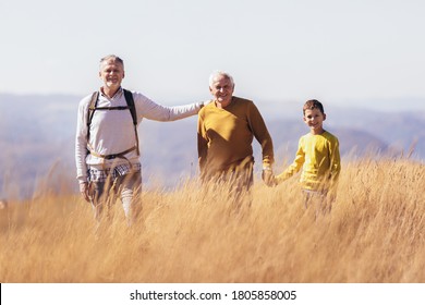 Three Generations Of Family Hiking Together In The Autumn.