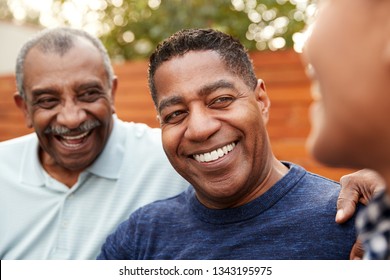 Three Generations Of Family Men Laughing Together, Close Up