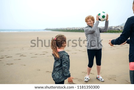 Similar – Three generations female playing on the beach