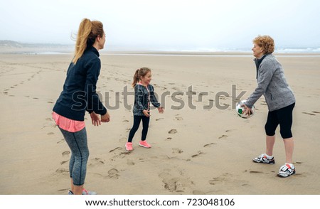 Similar – Three generations female playing on the beach