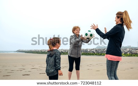 Similar – Three generations female playing on the beach