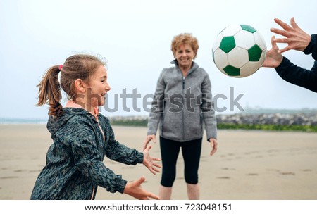 Similar – Three generations female playing on the beach