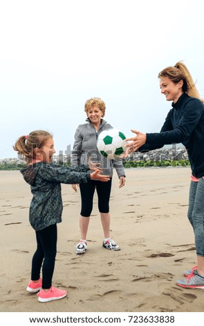 Three generations female playing on the beach