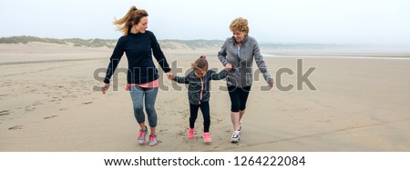 Similar – Little girl running with women on beach