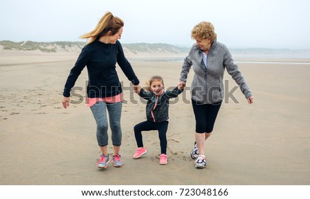 Similar – Little girl running with women on beach