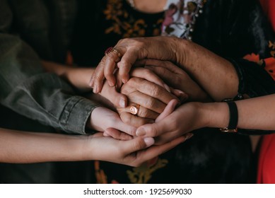 three generations of hands together - Shutterstock ID 1925699030