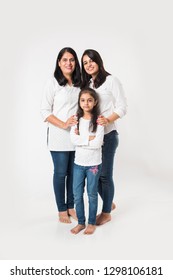 three generations of happy Indian women or females, standing isolated over white background. selective focus