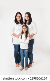 three generations of happy Indian women or females, standing isolated over white background. selective focus