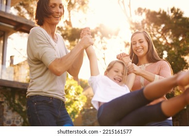 Three Generations Having Great Fun. Shot Of A Little Girl Playing Outside With Her Mother And Grandmother.