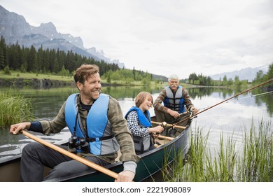 Three generations of men fishing in lake - Powered by Shutterstock