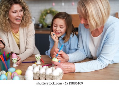 Three generations of women decorate easter eggs                                - Powered by Shutterstock