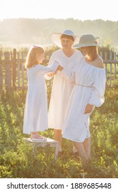 Three Generations Of Women Of The Same Family At Sunset