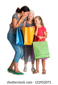 Three Generations Of Women With Shopping Bags On A White Background