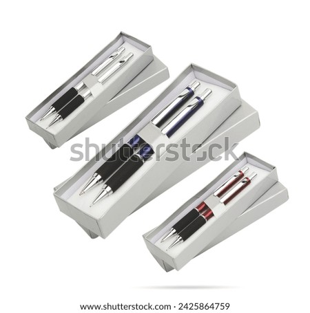 Three gift pens in classy, opened soft plastic or paper pencil box. Gift box packaging for promotional branding. Promotional gift twin pens in box. Silver, blue and red colored pens.