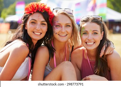 Three Girl Friends At A Music Festival Looking To Camera