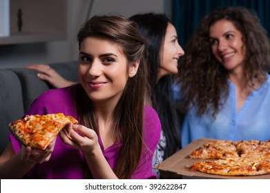 Three Girlfriends Eating Pizza at home