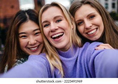 Three Girlfriends Having Fun Taking A Selfie
