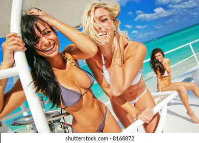 three girls having fun on a boat in the tropics