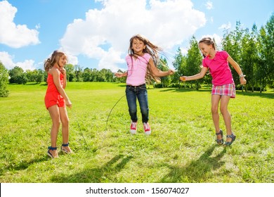 Three Girls Jumping Over The Rope In The Park, Having Fun In Active Games Outside