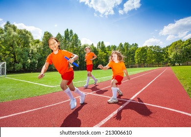 Three Girls With One Relay Baton Running