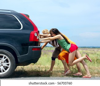 Three Girls Push The Broken Car