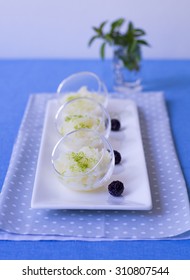 Three Glass Bowls With Melon Granita And Lime Zest 