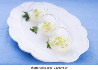 Three Glass Bowls With Melon Granita And Lime Zest 