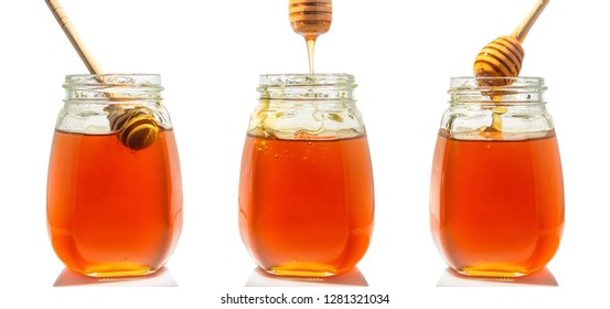  three glass jars with honey and wooden spoons for honey