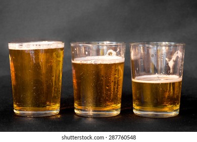 Three Glasses Of Beer, One Full, One Half Full And One Empty 