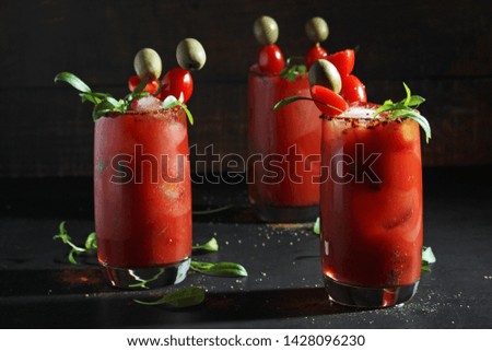 Three glasses with Bloody Mary cocktail	